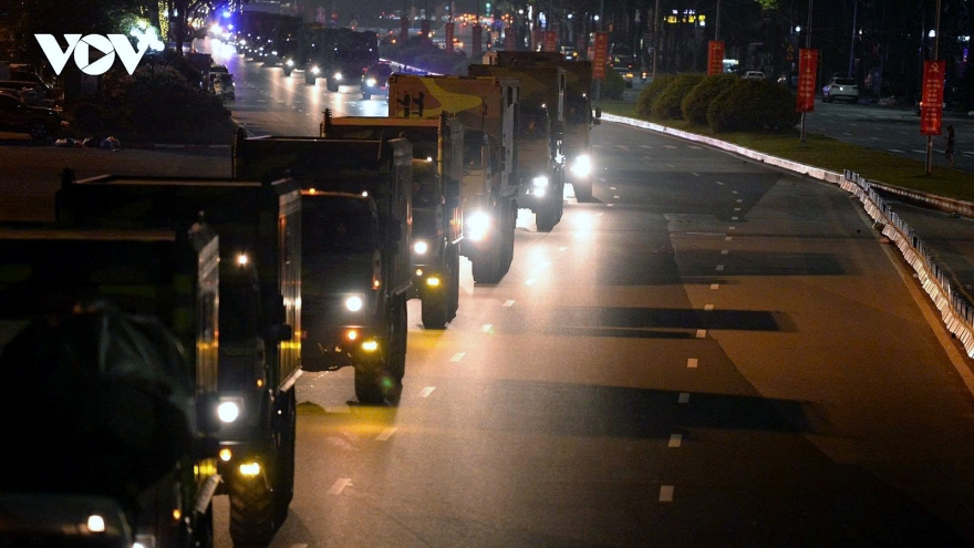Convoy of military hardware moves into Hanoi city centre at night for military parade